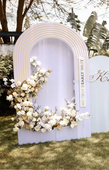 White arch photo booth backdrop with flowers