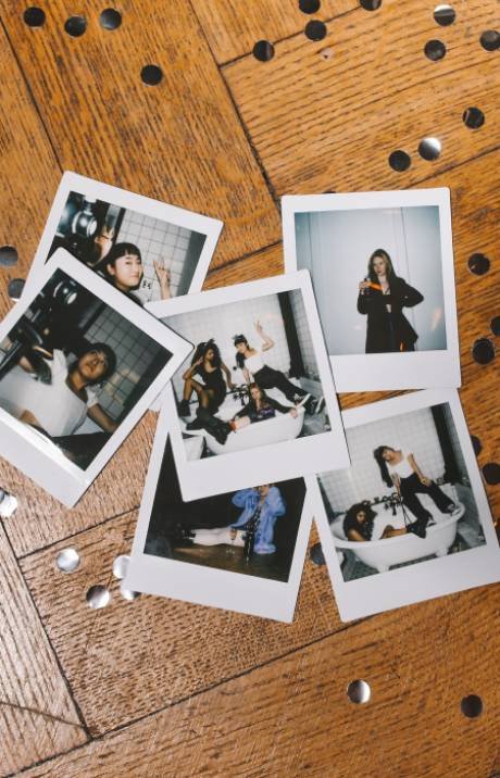 Instant photo booth prints on a wooden table