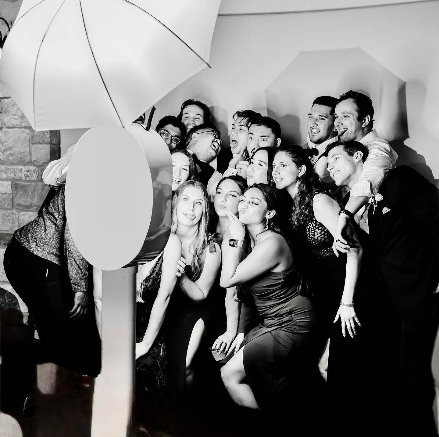 Wedding guests laughing together in a photo booth